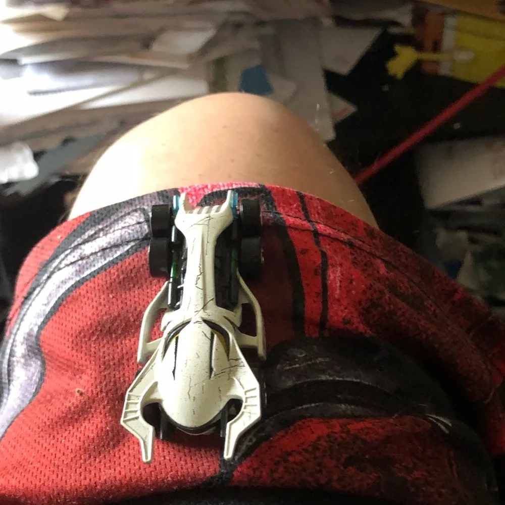 White Skull-Style Toy Race Car with Yellow Accents